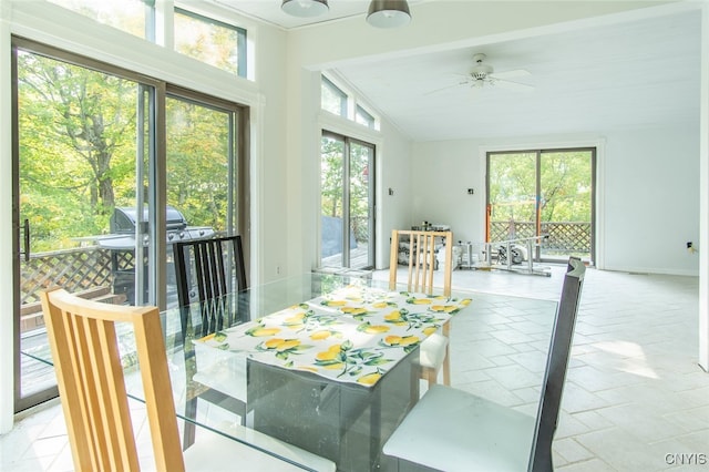 dining room featuring lofted ceiling, ceiling fan, and a wealth of natural light