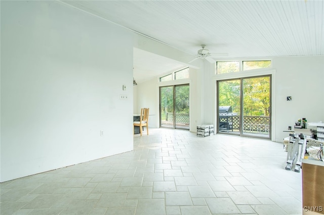 unfurnished living room featuring lofted ceiling and ceiling fan