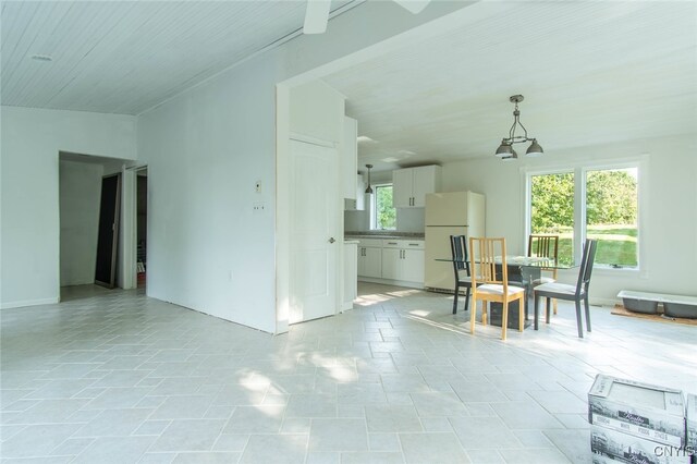 unfurnished dining area with an inviting chandelier and light tile patterned floors