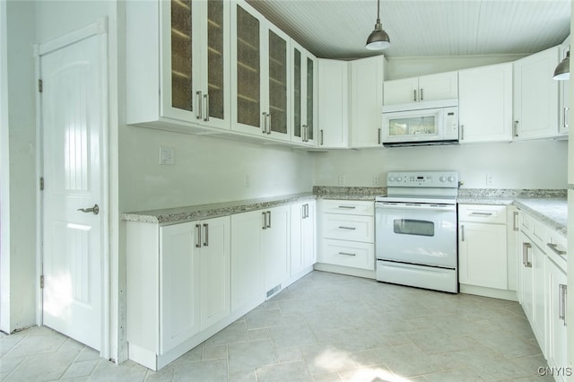 kitchen featuring light stone counters, vaulted ceiling, white cabinetry, white appliances, and decorative light fixtures