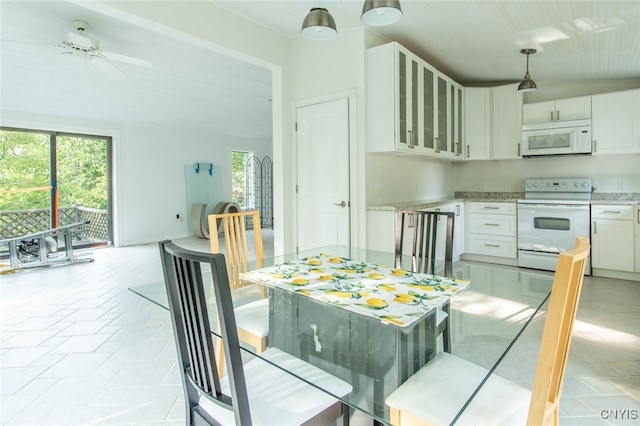 dining room featuring ceiling fan and vaulted ceiling