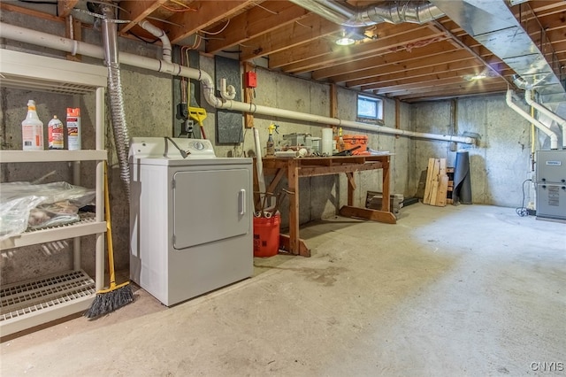 basement featuring a workshop area and washer / clothes dryer