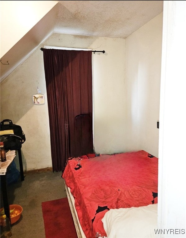 carpeted bedroom featuring a textured ceiling