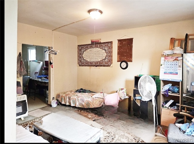 bedroom featuring concrete flooring and heating unit