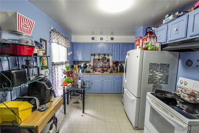 kitchen featuring white appliances and blue cabinetry