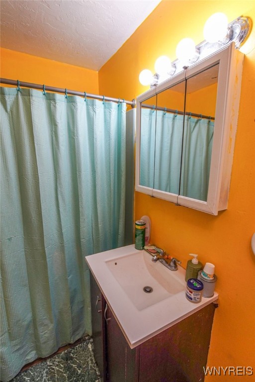 bathroom with vanity and a textured ceiling