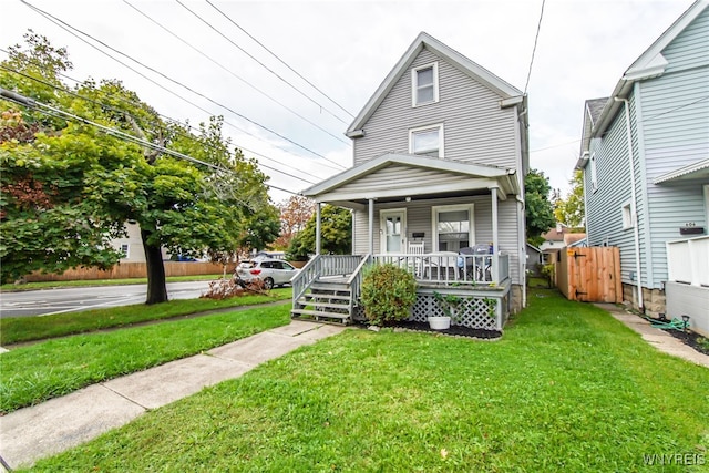 view of front of home with a porch and a front yard