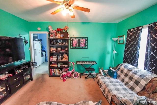 carpeted living room with washer / clothes dryer and ceiling fan