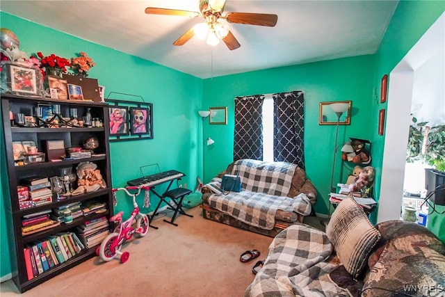 sitting room with ceiling fan and carpet floors