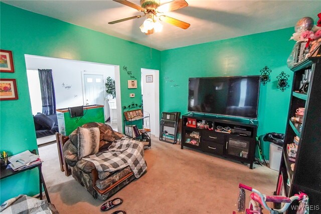 carpeted living room with ceiling fan