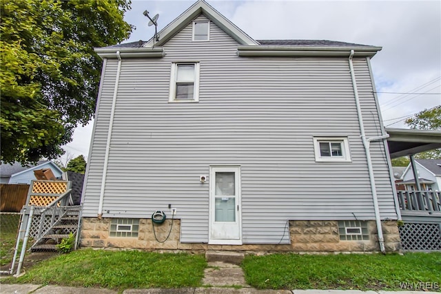 rear view of house featuring a deck