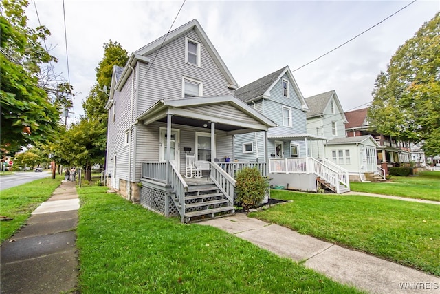 view of front of property with a porch and a front lawn