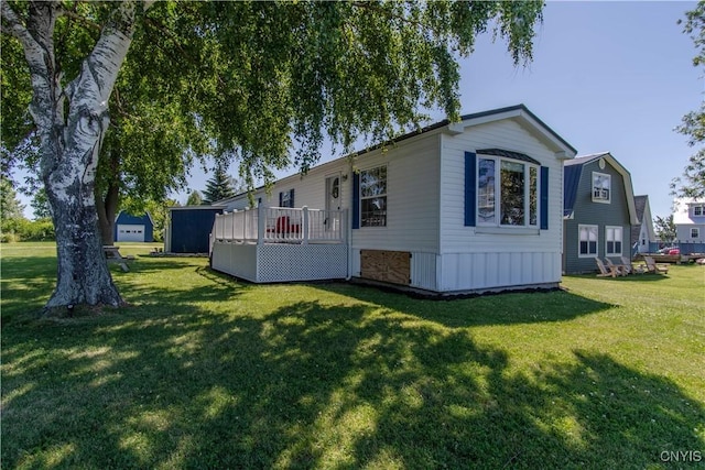 rear view of house featuring a lawn