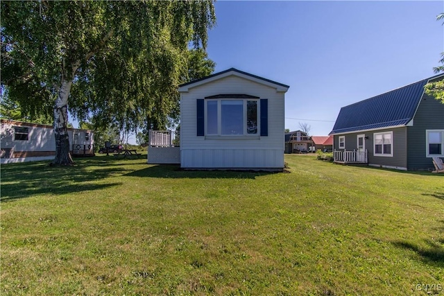 rear view of property with a lawn