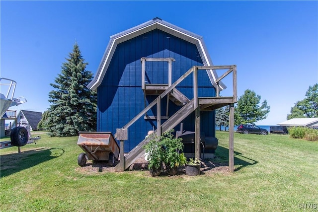 rear view of property with a lawn and a gambrel roof