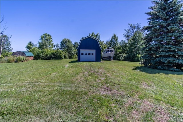 view of yard with an outbuilding and a detached garage