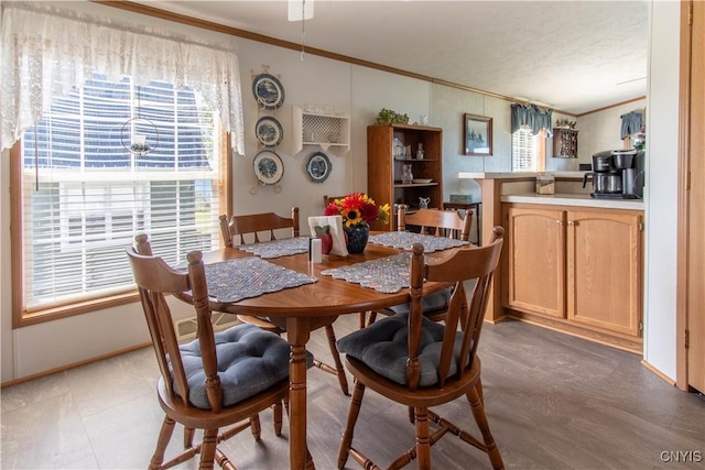 dining area featuring baseboards and ornamental molding