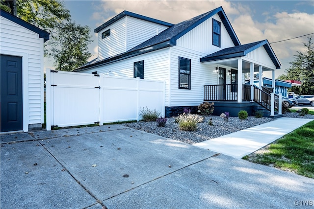 view of property exterior with a porch