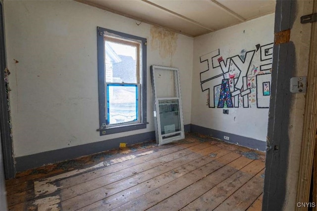 unfurnished room featuring hardwood / wood-style flooring