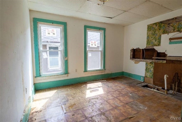 interior space with a paneled ceiling