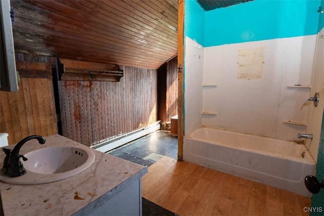 bathroom featuring vanity, a baseboard radiator, wooden walls, and shower / bathtub combination