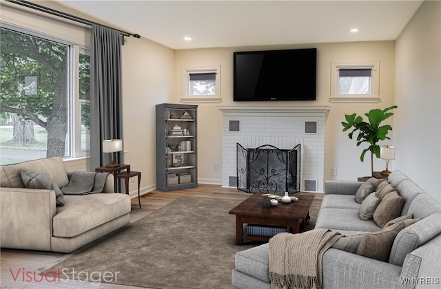 living room featuring a brick fireplace and light wood-type flooring