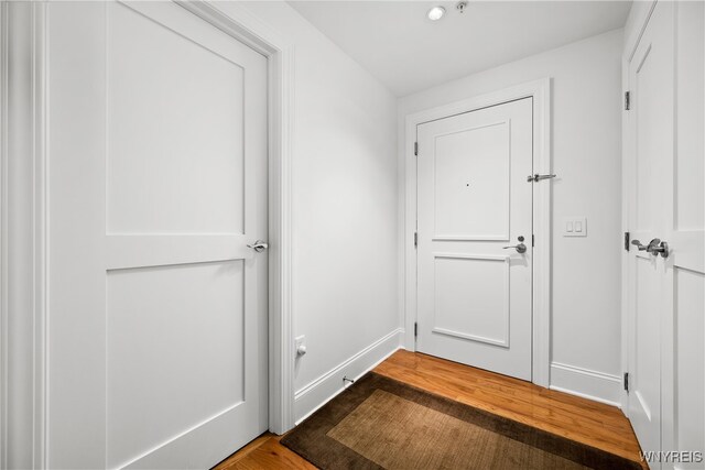 doorway with hardwood / wood-style flooring