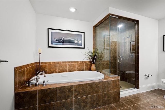 bathroom with toilet, plus walk in shower, and tile patterned floors