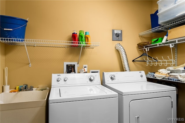 laundry area featuring washer and clothes dryer and sink