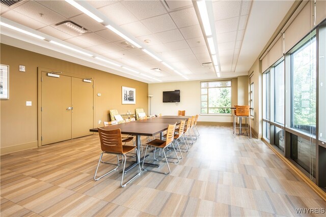 dining area with a paneled ceiling