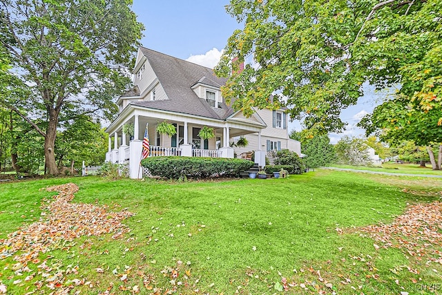 view of front of home with a front yard and a porch