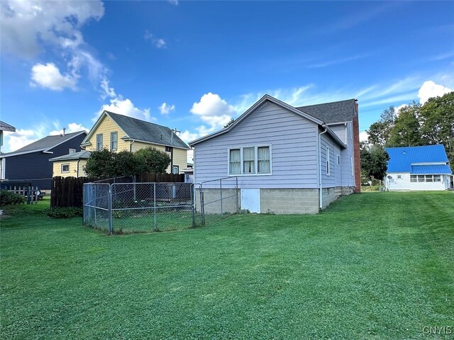 back of property featuring a lawn