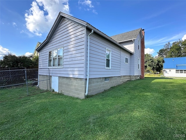 view of side of home featuring a lawn