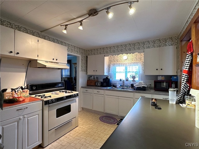 kitchen featuring rail lighting, white cabinetry, white range oven, and sink