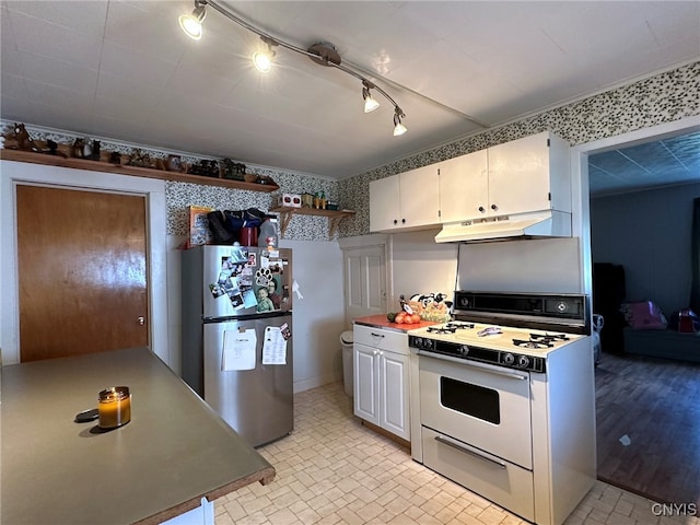 kitchen with white cabinets, stainless steel refrigerator, white range, and light hardwood / wood-style floors