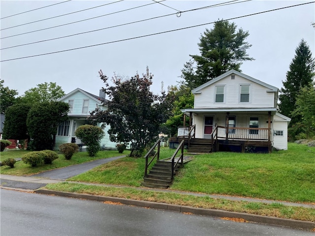 view of front of house featuring a front lawn and covered porch