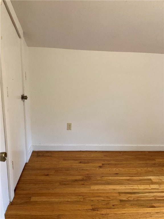 empty room with hardwood / wood-style flooring