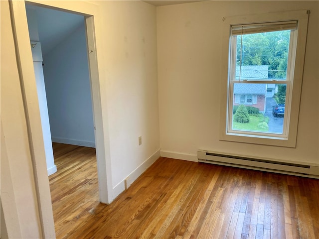 unfurnished room featuring light hardwood / wood-style flooring and baseboard heating