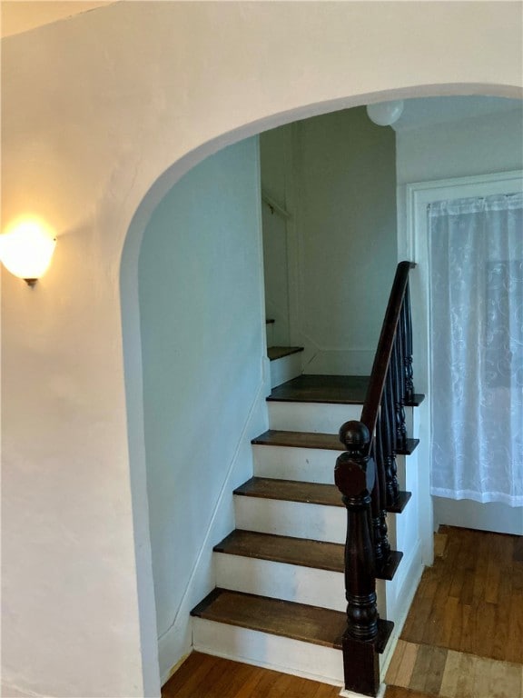 stairs featuring hardwood / wood-style flooring