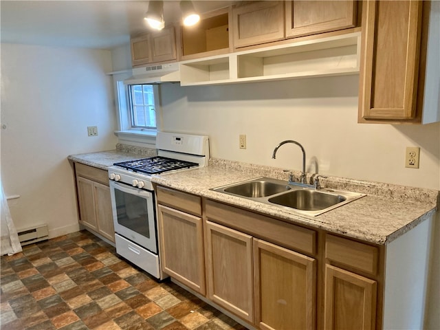 kitchen with light brown cabinetry, gas stove, baseboard heating, and sink