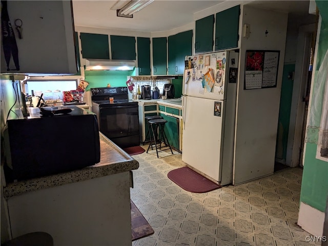 kitchen featuring green cabinetry, black range with electric stovetop, and white fridge