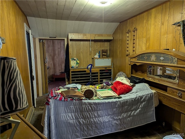 bedroom featuring vaulted ceiling, baseboard heating, and wood walls