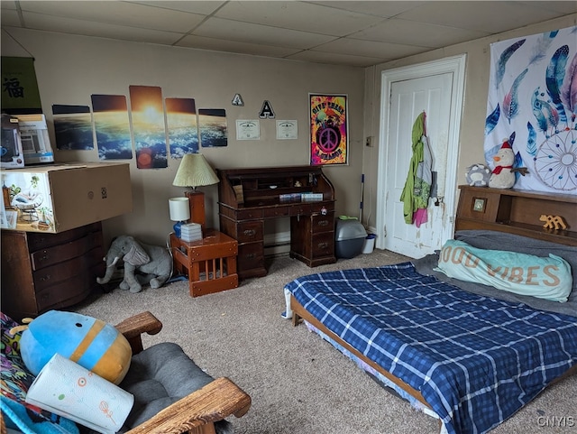 bedroom featuring a paneled ceiling and carpet flooring