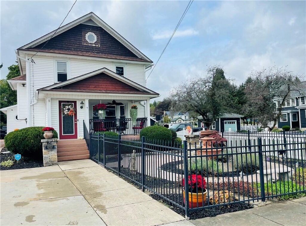 view of front of property with a porch and a garage