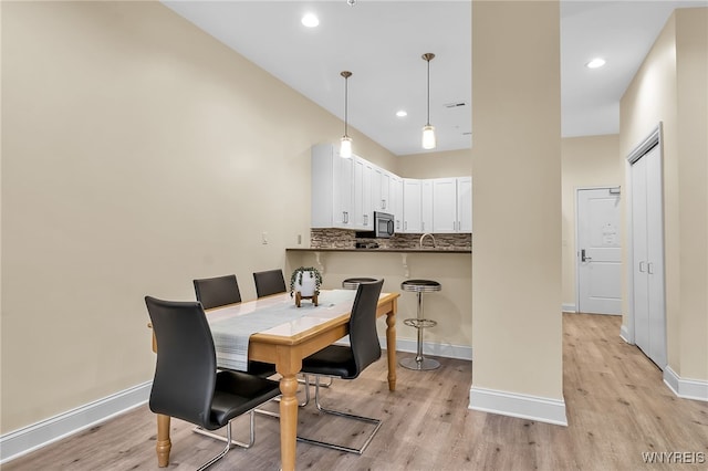 dining space with light hardwood / wood-style floors