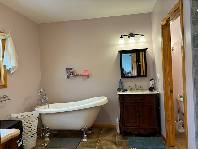 bathroom with a bath, tile patterned flooring, and vanity