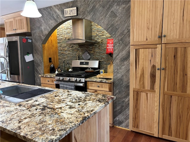 kitchen featuring light stone countertops, stainless steel appliances, dark hardwood / wood-style floors, and wall chimney range hood