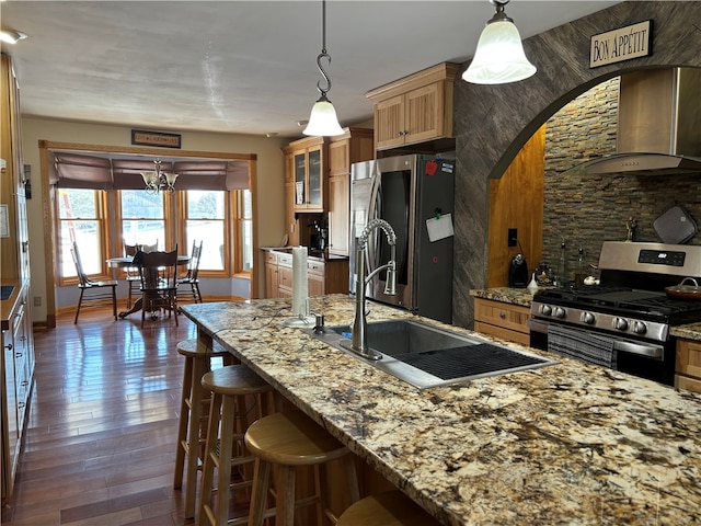 kitchen featuring wall chimney exhaust hood, stainless steel appliances, dark hardwood / wood-style floors, and hanging light fixtures