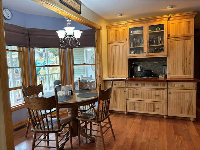 dining space featuring light wood-type flooring and a chandelier