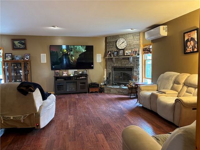 living room featuring a fireplace, hardwood / wood-style floors, and a wall mounted AC